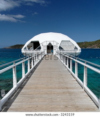 White bridge and cottage in blue caribbean water