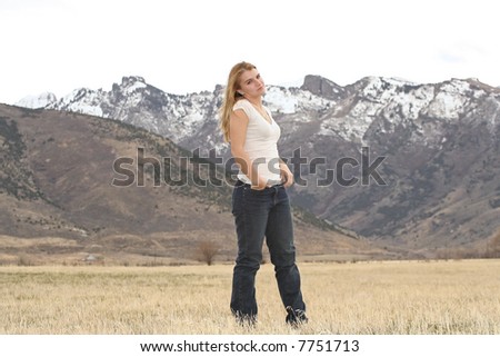 pretty young woman standing in field