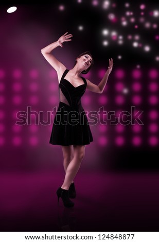 smiling dancer performing on the stage under the lights