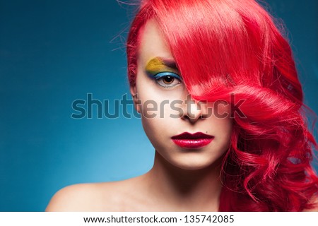 portrait of a young beautiful female model with colorful hair and makeup