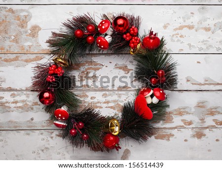 evergreen christmas wreath on old wooden door background
