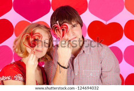 studio shot of young couple in love over colorful background