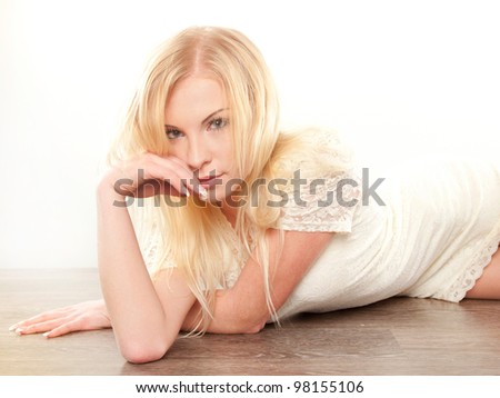 young beautiful blonde woman laying on the floor