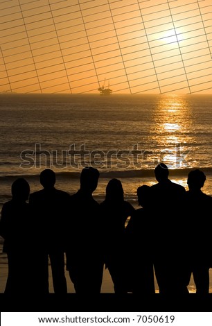 Business team shadow outline against a setting sun on the ocean