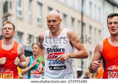 LONDON - APRIL 26: Unidentified man runs the Virgin Money London Marathon on April 26, 2015 in Isle of Dogs, London, England, UK.