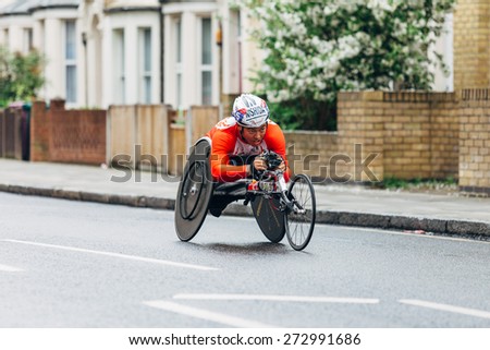 LONDON - APRIL 26: Wheelchair runner in the Virgin Money London Marathon on April 26, 2015 in Isle of Dogs, London, England, UK.