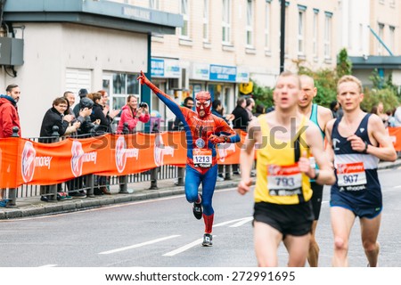 LONDON - APRIL 26: Man in Spiderman costume runs the Virgin Money London Marathon on April 26, 2015 in Isle of Dogs, London, England, UK.
