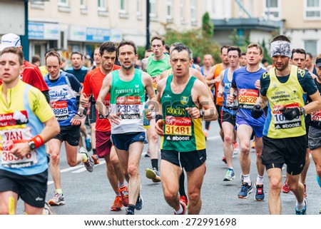 LONDON - APRIL 26: Group of unidentified men run in the Virgin Money London Marathon on April 26, 2015 in Isle of Dogs, London, England, UK.