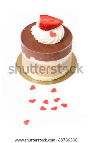 chocolate cappuccino layer cake with strawberry and hearts confetti isolated on white background