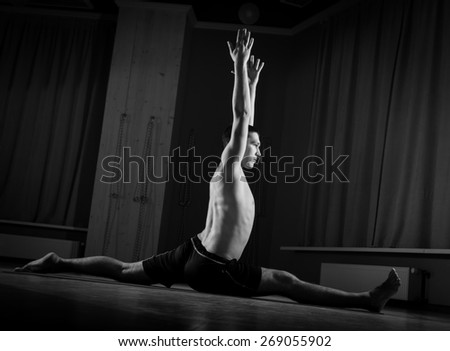 young man doing yoga in the gym, black and white