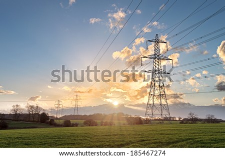 Electricity Pylon - UK standard overhead power line transmission tower at sunset.