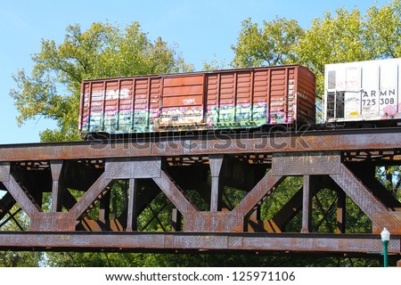 LOUISVILLE, KY - NOVEMBER 10: A CSX train crosses over a steel railroad truss drawbridge over the Ohio River, on November 10, 2012 in Louisville, Kentucky. This bridge was built in 1868.