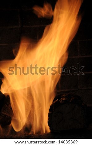 Fire flames with brick fireplace visible in the background