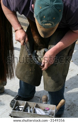 a blacksmith at work hammering a nail