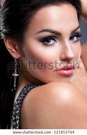 Portrait of a glamorous brunette girl with evening make up and long lashes