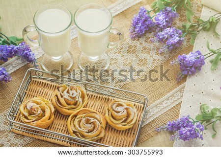Breakfast with tasty homemade apple cakes and milk over sackcloth background in provence style with lavanda