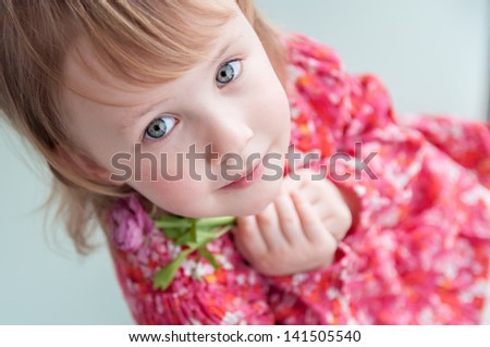 Small Blonde Girl at the rose flowers