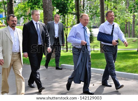 BUCHA, UKRAINE - 31 MAY 2013: The president of Ukraine Leonid Kuchma, major of Bucha town Anatoliy Fedoruk and unknown persons meet for opening of vocal festival on May 31, 2013 in Bucha, Ukraine.