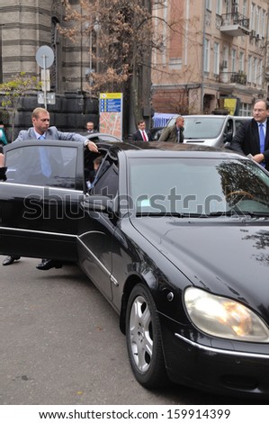 KIEV, UKRAINE Ã¢Â?Â? 22 OCTOBER 2013: Unkonwn security opens the door of VIP car near the embassy of Poland on October 22, 2013 in Kiev, Ukraine.