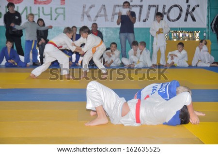 KOTSYUBYNSKE, UKRAINE - SEPTEMBER 3: Unknown boys make the duel fight on the youth judo competition on September 3, 2013 in Kotsyubynske, Ukraine.