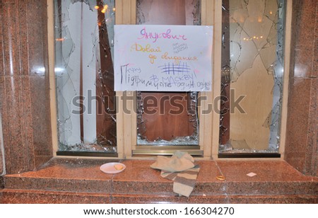 KIEV, UKRAINE Ã¢Â?Â? 2 DECEMBER 2013: Broken windows in the Kiev city-hall during the Ukrainian revolution with poster Ã¢Â?Â?Yanukovych goodbye in Moscow!Ã¢Â?Â� on December 2, 2013 in Kiev, Ukraine.