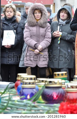 KIEV, UKRAINE - CIRCA FEBRUARY 2014: Unknown people pray on a requiem mass by died people during Ukrainian revolution on February 2014 in Kiev, Ukraine.