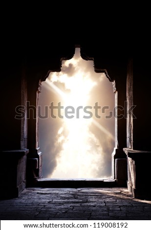 Indian arch silhouette in old temple at dramatic dark blue sunset sky background. Free space for text