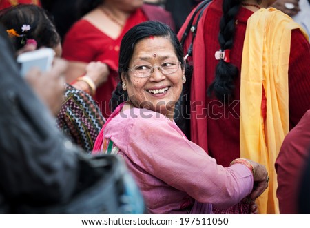 SWAYAMBHUNATH, KATHMANDU, NEPAL - APRIL 5, 2014: Happy Nepali woman in sari at religious festival near Swayambhunath stupa