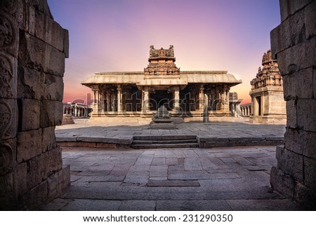 Ancient temple with columns at violet sky in Hampi, Karnataka, India