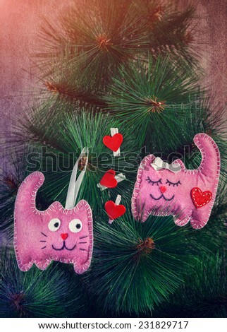 Handmade pink cats in love with hearts on the tree