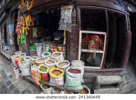 THAMEL, KATHMANDU, NEPAL - APRIL 4, 2014: Man looking through the window near the street grocery shop