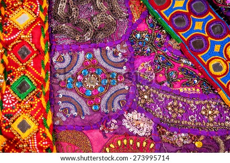 Colorful ethnic Rajasthan cushion cover and belts with mirrors on flea market in India