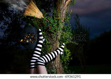 Witch in striped long socks has fallen from her broomstick at night