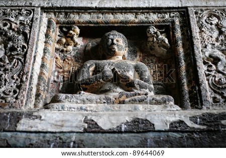 Ancient Buddha statue sitting inside Ajanta Cave in Maharashtra, India