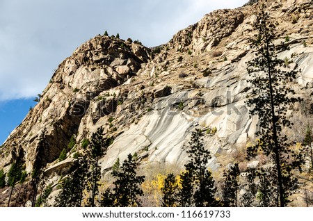 Rocky, mountain terrain with beautiful patterns in the rocks and bits of yellow fall color at Lost Creek State Park in Montana