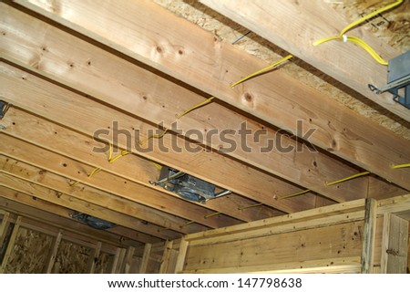 Boxes and wiring installed in ceiling of residential structure for can lights