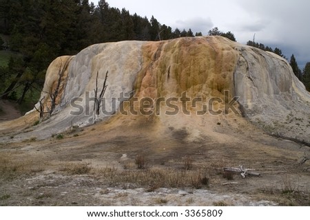 Orange Spring Mound, at Mammoth Hot Springs in Yellowstone National  Park, gradually grows as the water flows over it depositing calcium carbonate, or travertine.