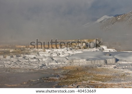 Hot springs terrace with mountains in the background near Mammoth Hot Springs in Yellowstone National Park in winter