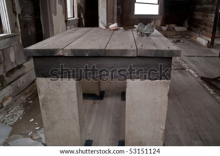 Study, heavy-duty table with concrete legs in the assay house of a Montana mining ghost town holds a few items left behind when the town was abandoned