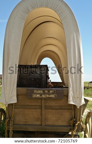Close-up of covered wagon with sun shining through the canvas