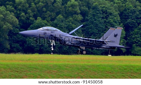SINGAPORE - MAY 28: Republic of Singapore Air Force (RSAF) F-15SG Strike Eagle landing on runway during RSAF Open House 2011 on May 28, 2011 in Singapore.