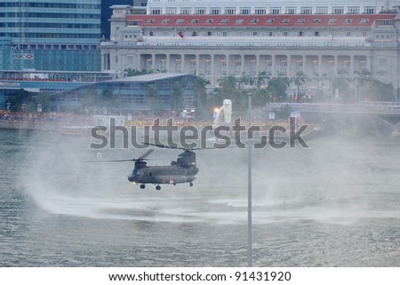 SINGAPORE - AUGUST 9: Chinook hovering over river during National Day Parade Singapore 2011 on August 9, 2011 in Singapore.