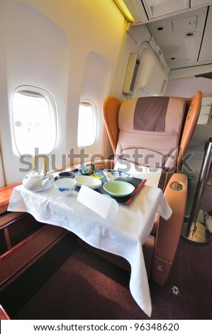 SINGAPORE - FEBRUARY 17: First class cabin seat with dining set on display in Singapore Airlines' (SIA) last Boeing 747-400 aircraft at Singapore Airshow on February 17, 2012 in Singapore