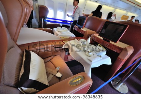 SINGAPORE - FEBRUARY 17: First class cabin service ware and flight entertainment in Singapore Airlines\' (SIA) last Boeing 747-400 aircraft at Singapore Airshow on February 17, 2012 in Singapore