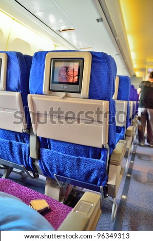 SINGAPORE - FEBRUARY 17: Inflight entertainment system in economy class cabin in Singapore Airlines\' (SIA) last Boeing 747-400 aircraft at Singapore Airshow on February 17, 2012 in Singapore