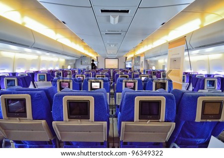 SINGAPORE - FEBRUARY 17: Economy Class cabin in Singapore Airlines\' (SIA) last Boeing 747-400 aircraft at Singapore Airshow on February 17, 2012 in Singapore