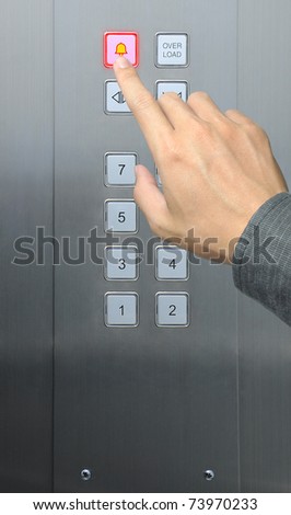 businessman hand press emergency  button in elevator