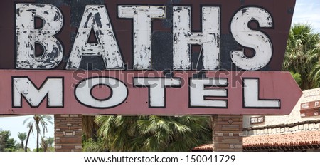 Old motel sign that advertised for hot mineral baths