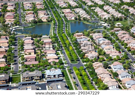 Tree lined streets in suburb with man made lakes in east Mesa, Arizona