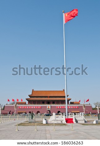 BEIJING, CHINA - MARCH 27: soldiers stands on attention next to national flag of China on Tiananmen square in front of Gate of Heavenly Peace on March 27, 2013 in Beijing